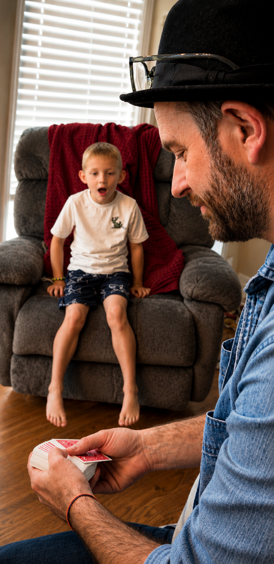 Young boy reacting with wide-eyed surprise to a magic trick at home